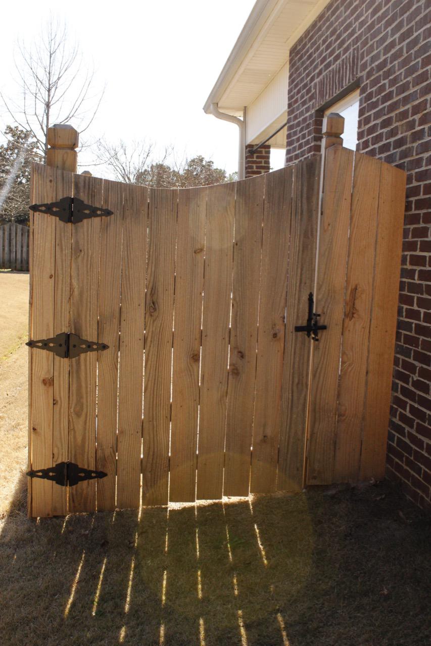 wood scalloped fence installed by top rail fence