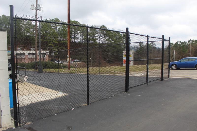black chain link fence installed by top rail fence