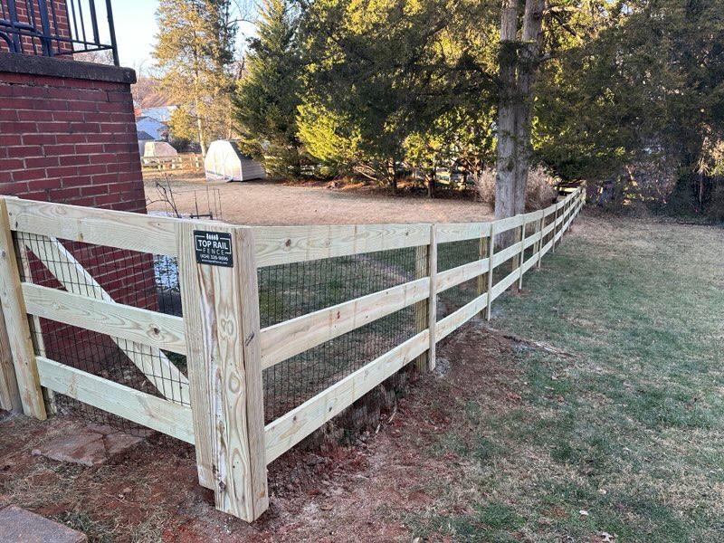 wood ranch rail fence installed by top rail fence