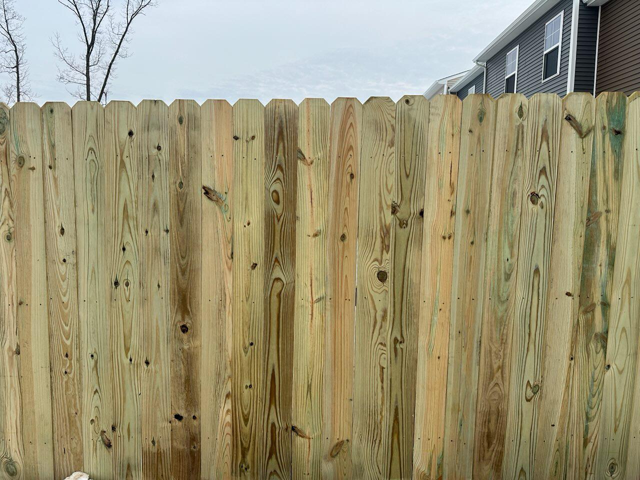 wood stockade fence installed by top rail fence
