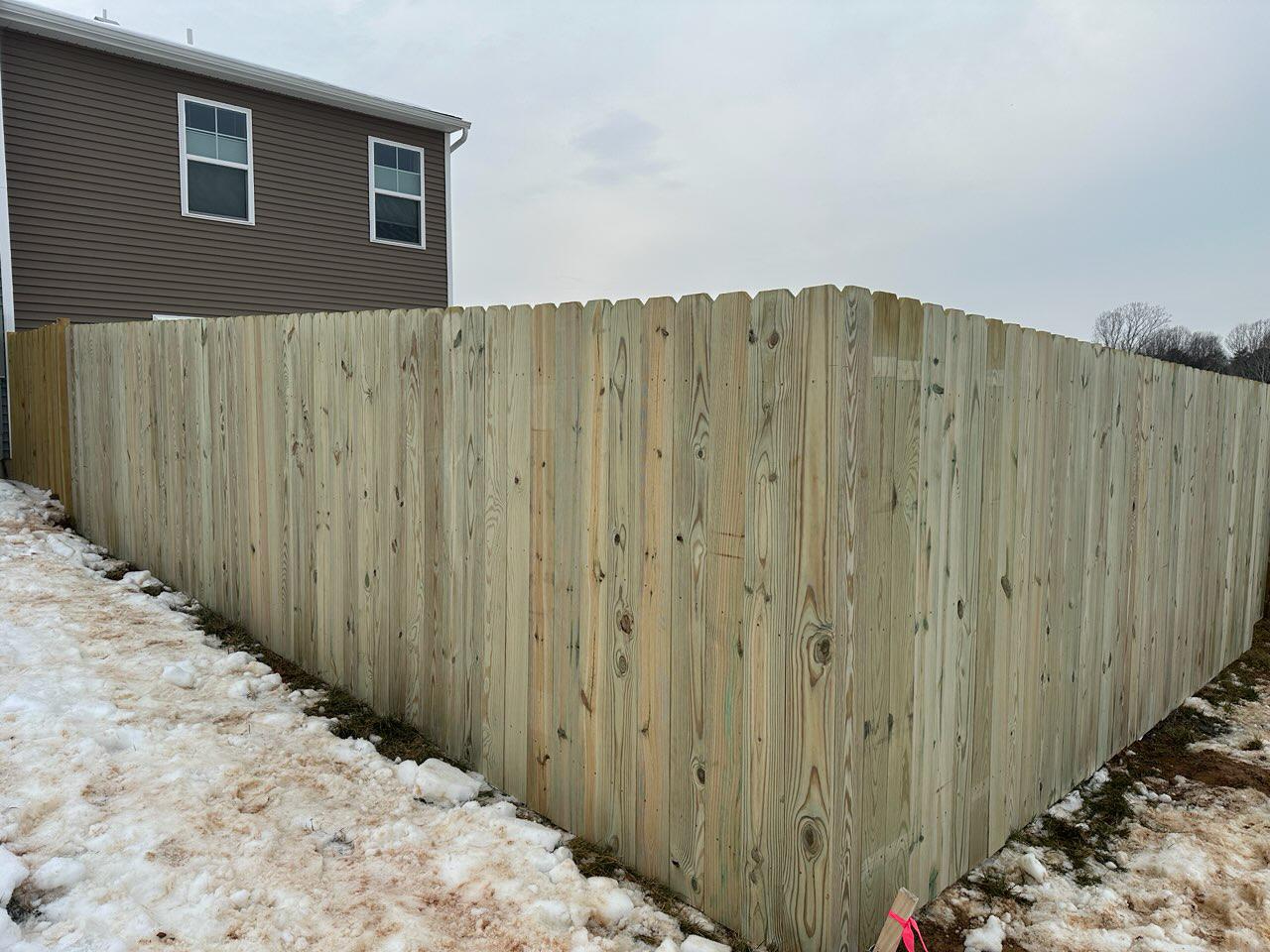 wood stockade fence installed by top rail fence