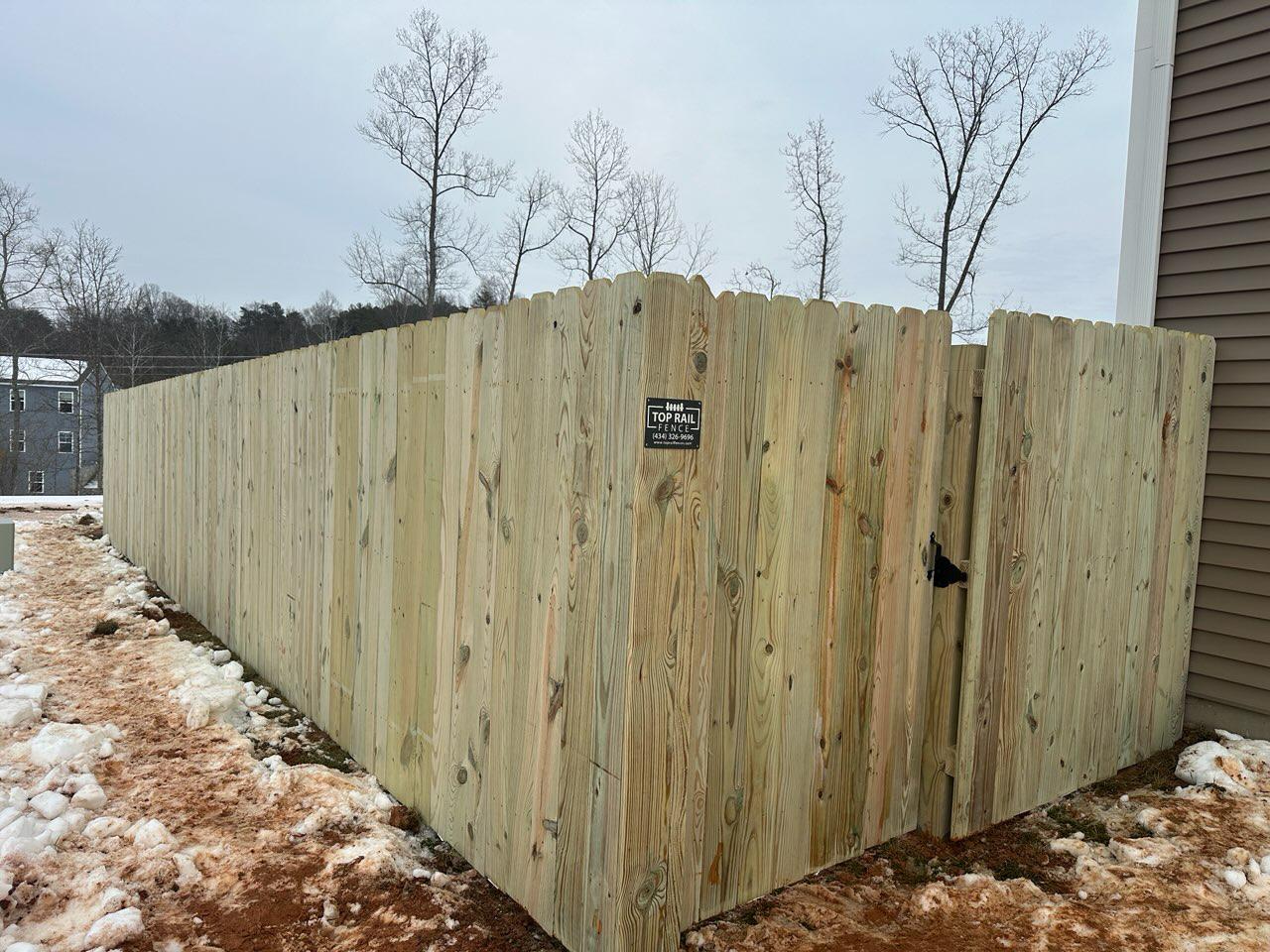 wood stockade fence installed by top rail fence 