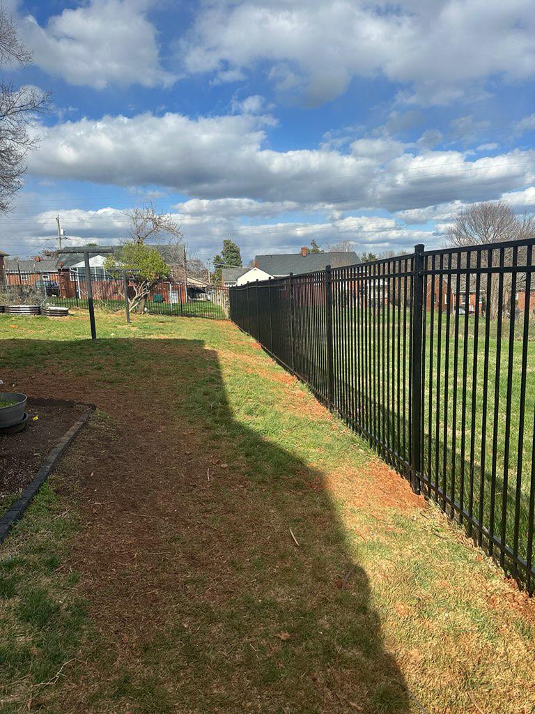three rail ornamental metal fence installed by top rail fence