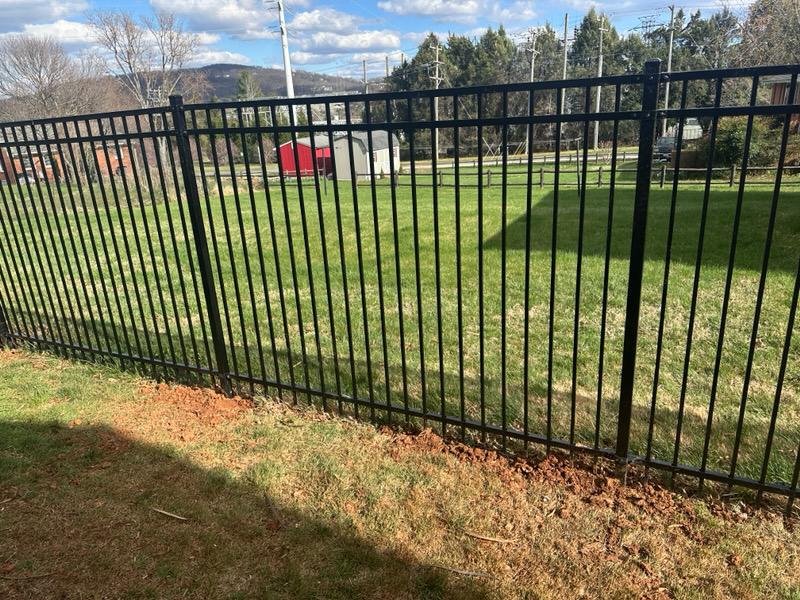 three rail ornamental metal fence installed by top rail fence