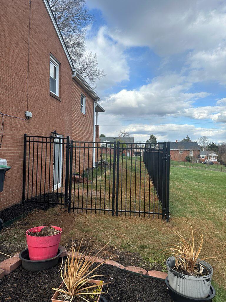 three rail ornamental metal fence installed by top rail fence
