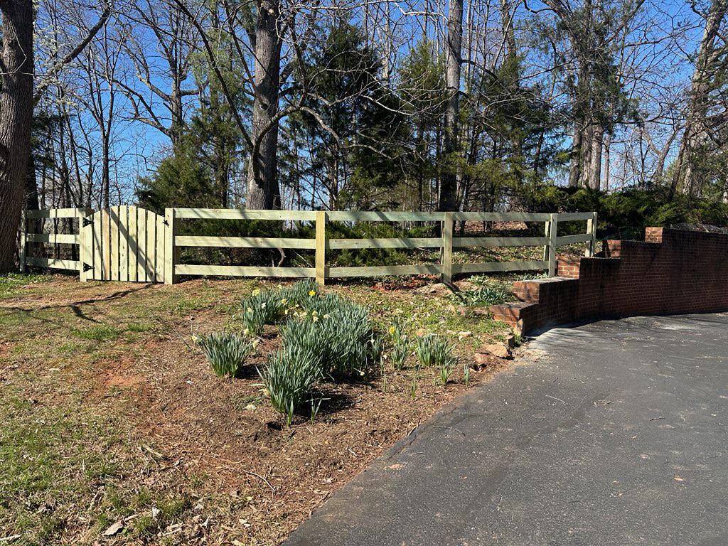 wood ranch rail fence installed by top rail fence
