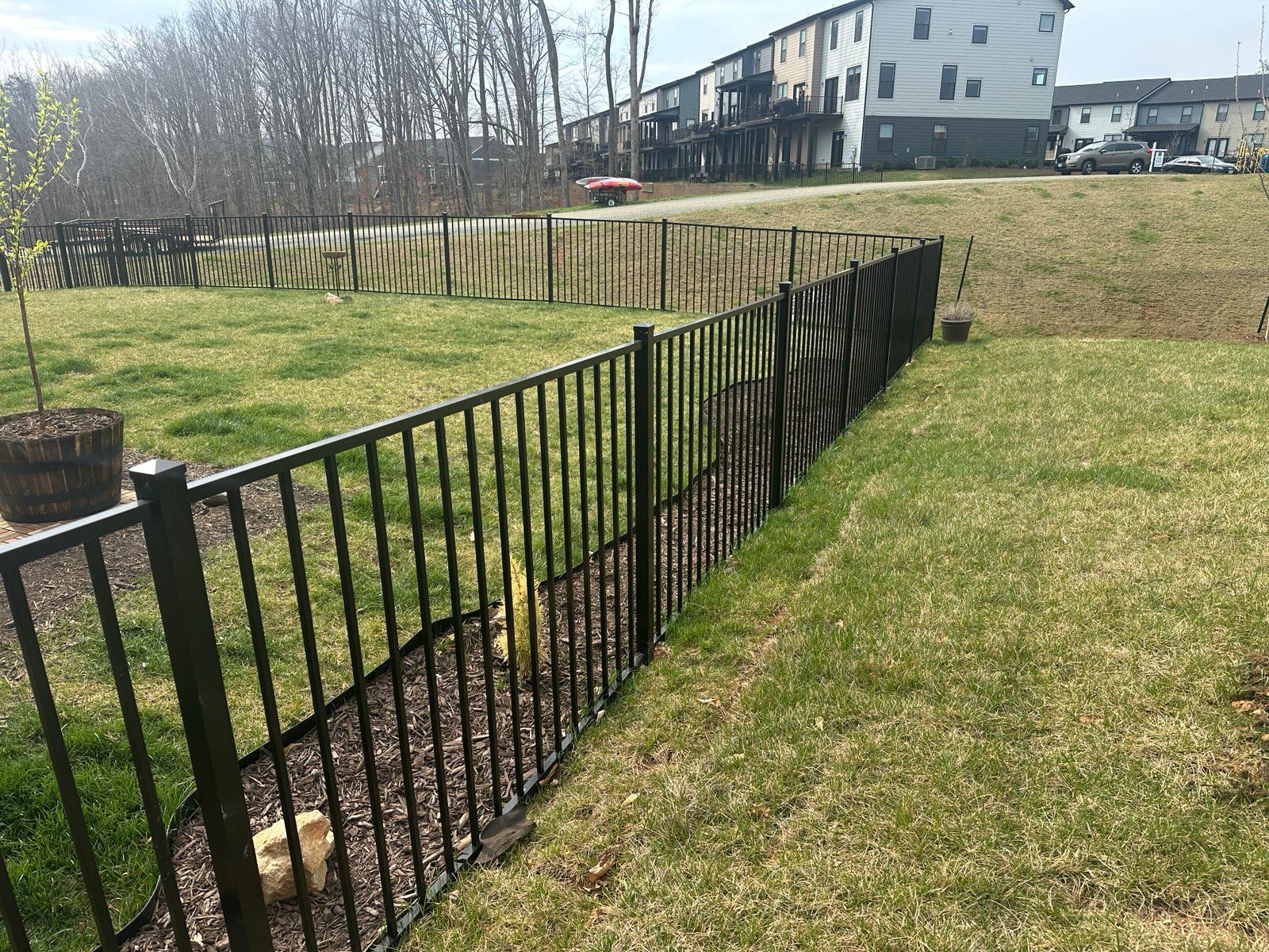 three rail ornamental metal fence installed by top rail fence