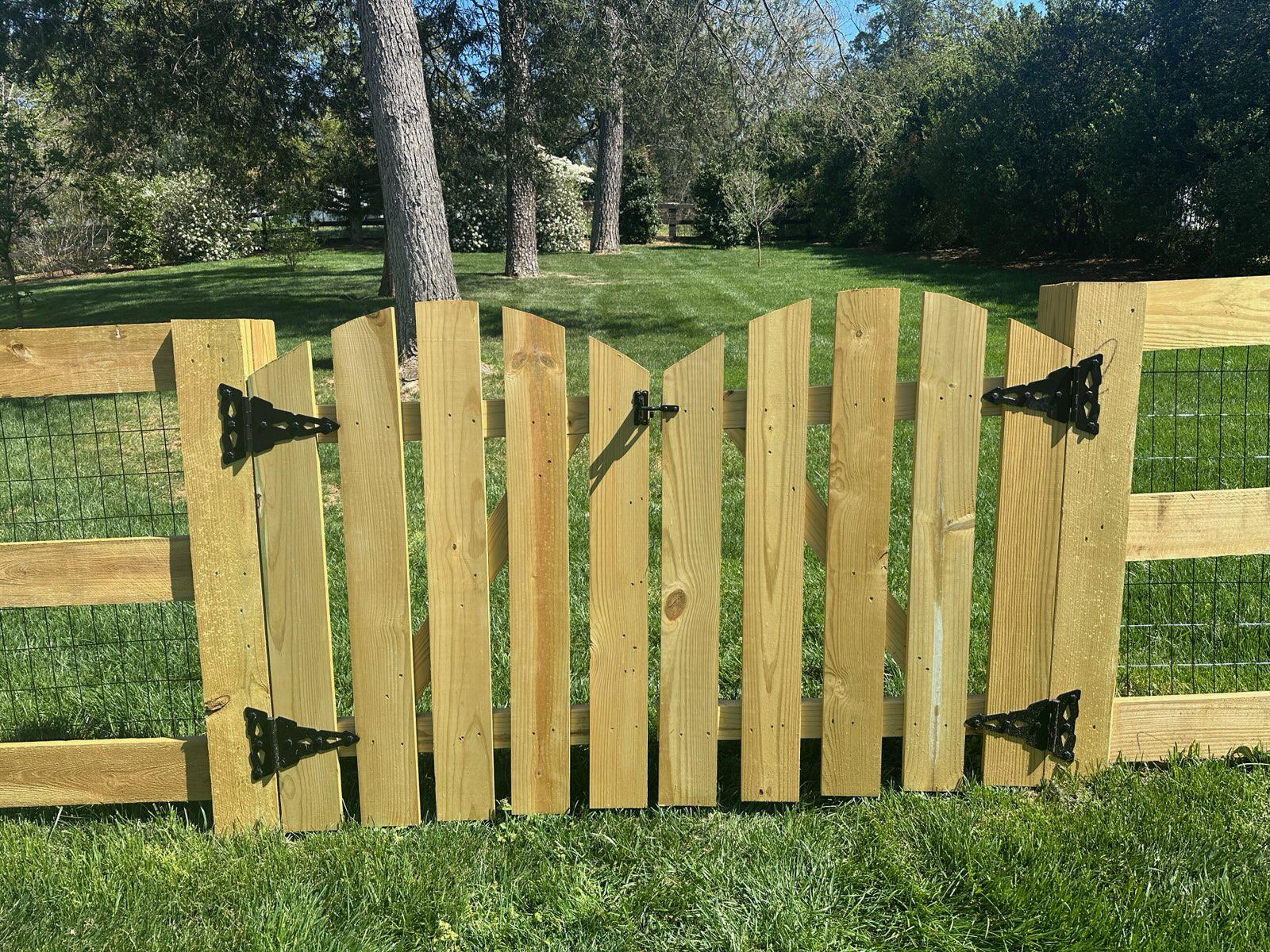 wood gate installed by top rail fence