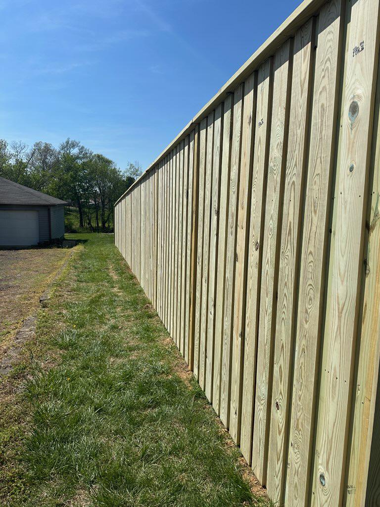 wood board on board installed by top rail fence