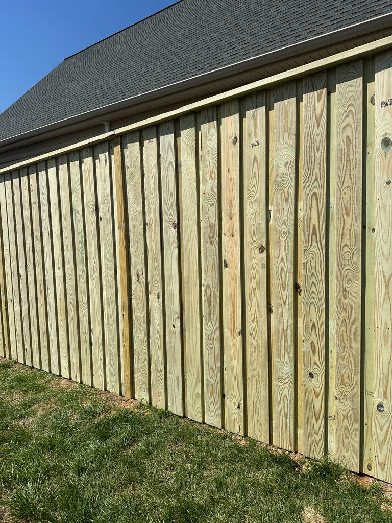 wood board on board installed by top rail fence
