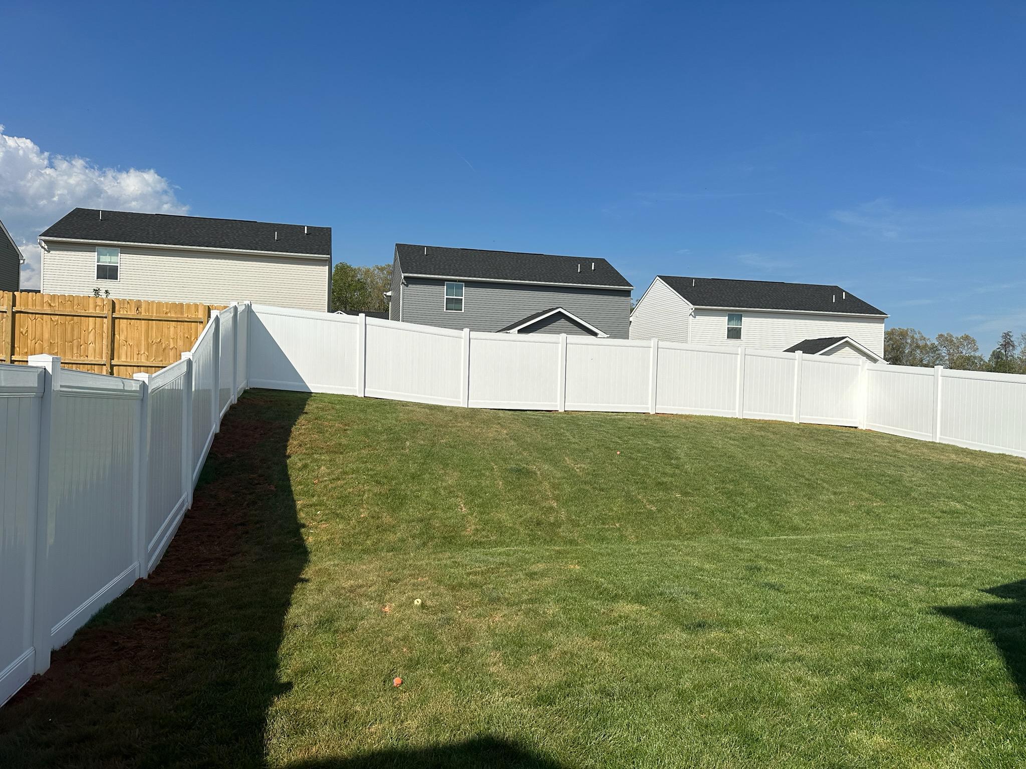 vinyl privacy fence installed by top rail fence