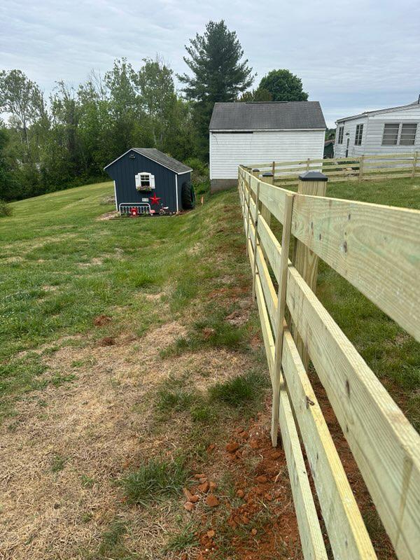 wood ranch rail fence installed by top rail fence