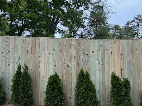 wood stockade fence installed by top rail fence