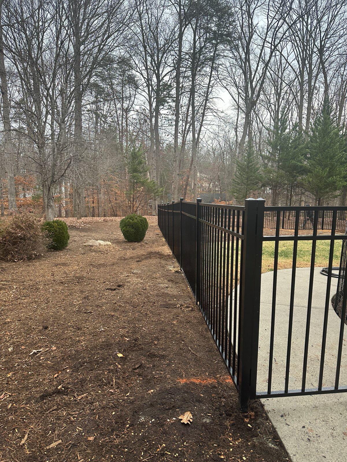 ornamental metal fence installed by top rail fence
