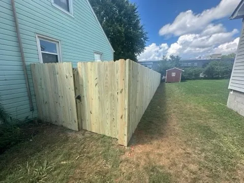 wood stockade fence installed by top rail fence