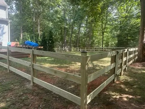 wood ranch rail fence installed by top rail fence