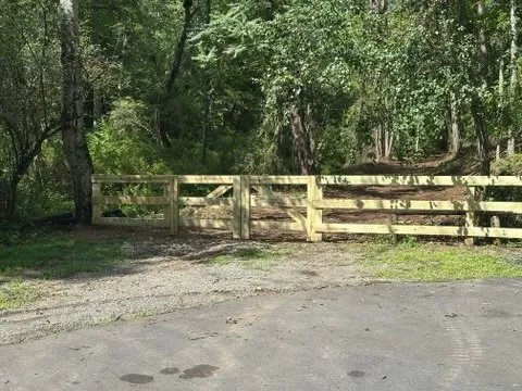 wood ranch rail fence installed by top rail fence