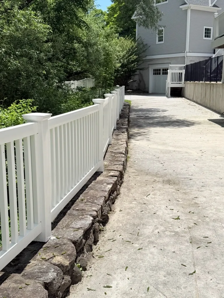 Vinyl picket fence installed by top rail fence