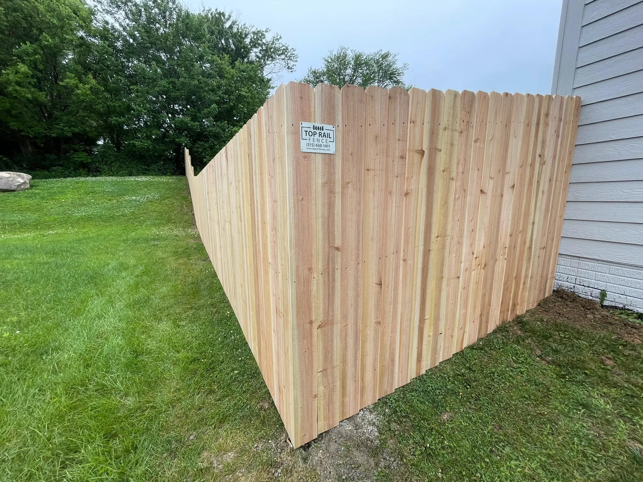 wood stockade fence installed by top rail fence