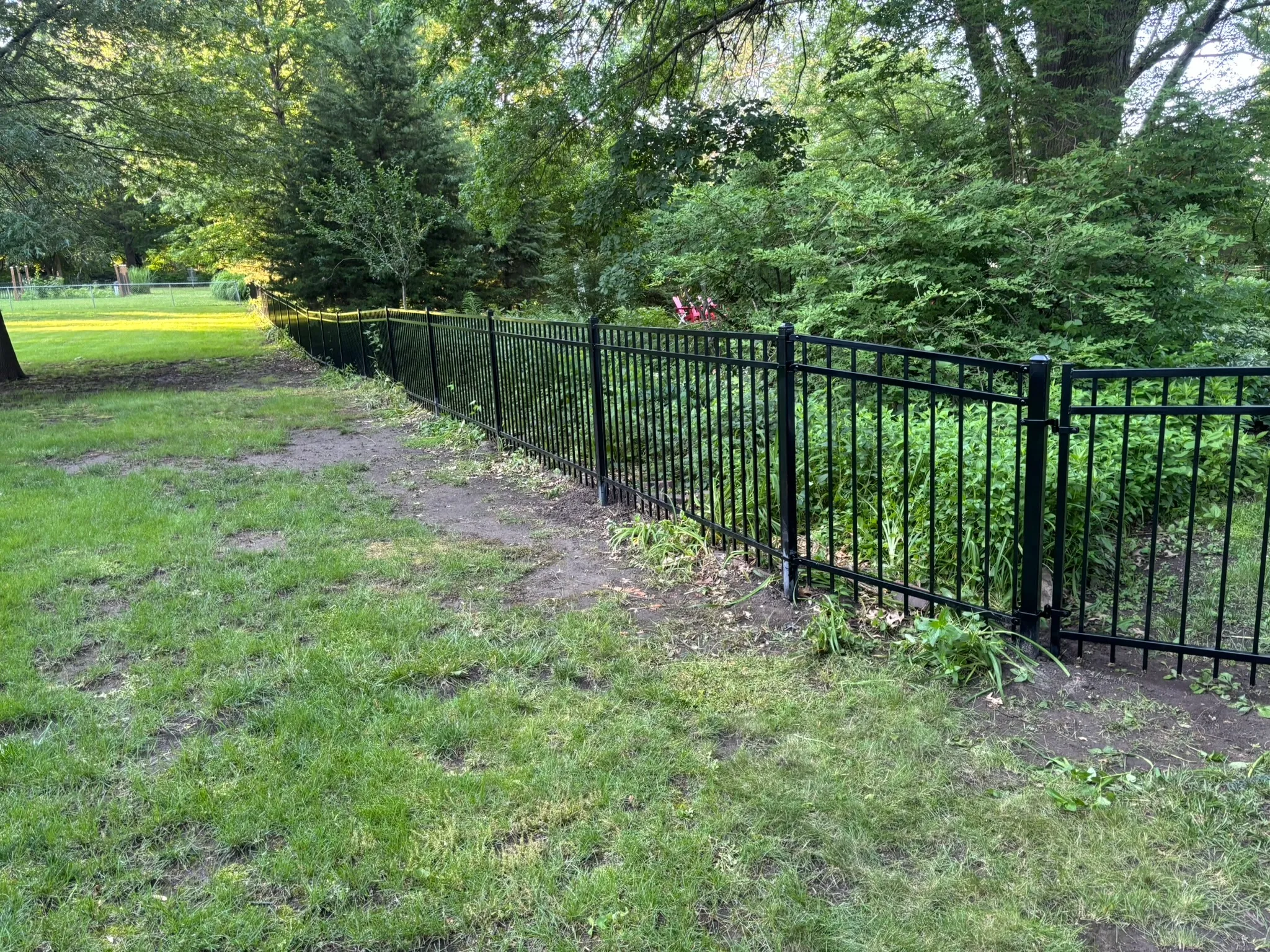 ornamental metal fence installed by top rail fence