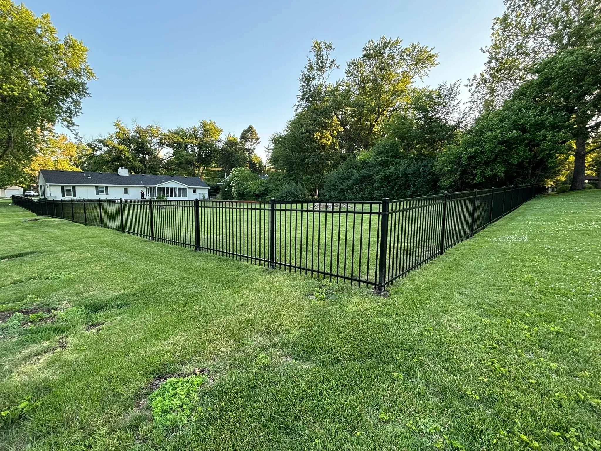 ornamental metal fence installed by top rail fence