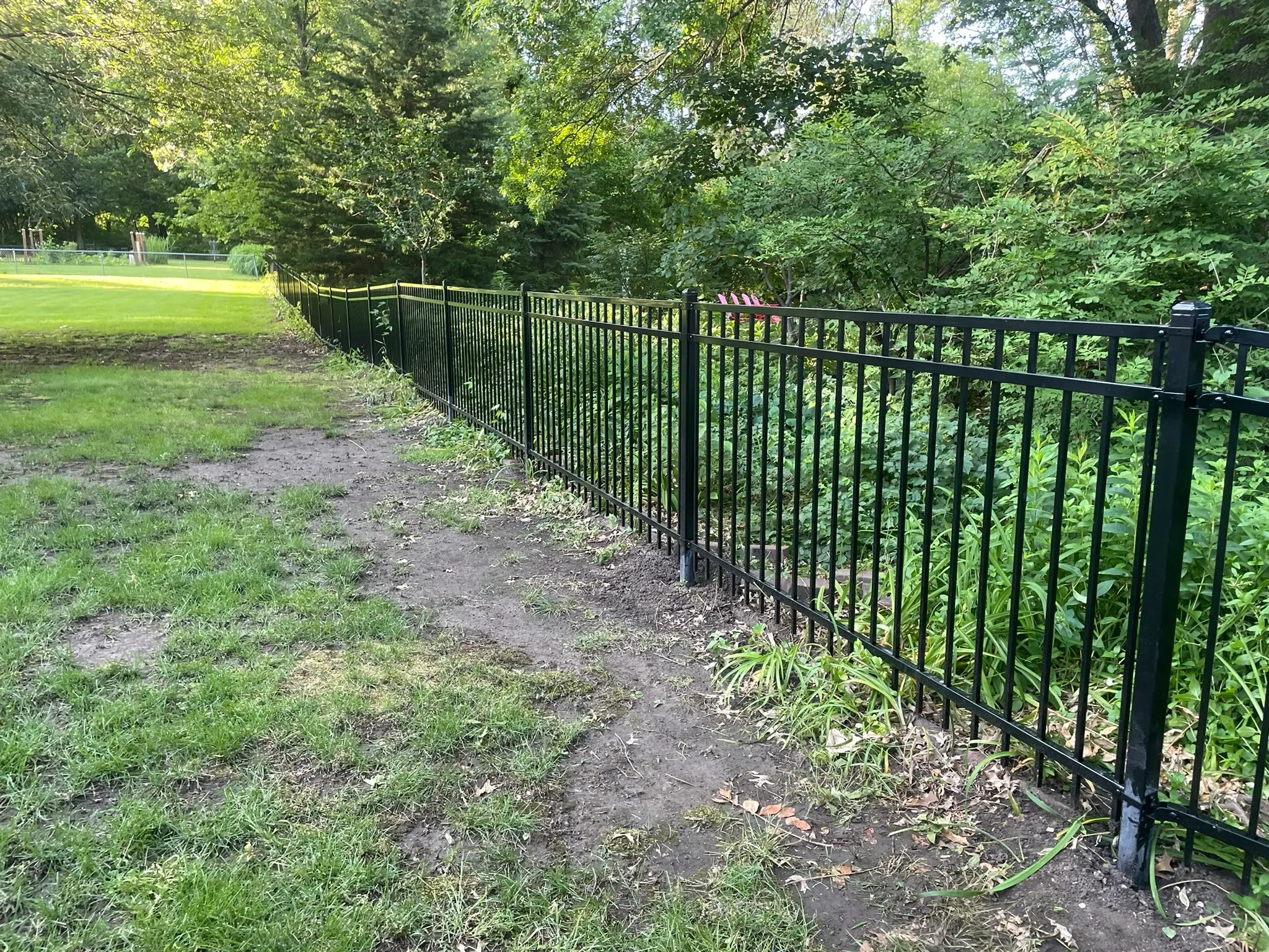 ornamental metal fence installed by top rail fence