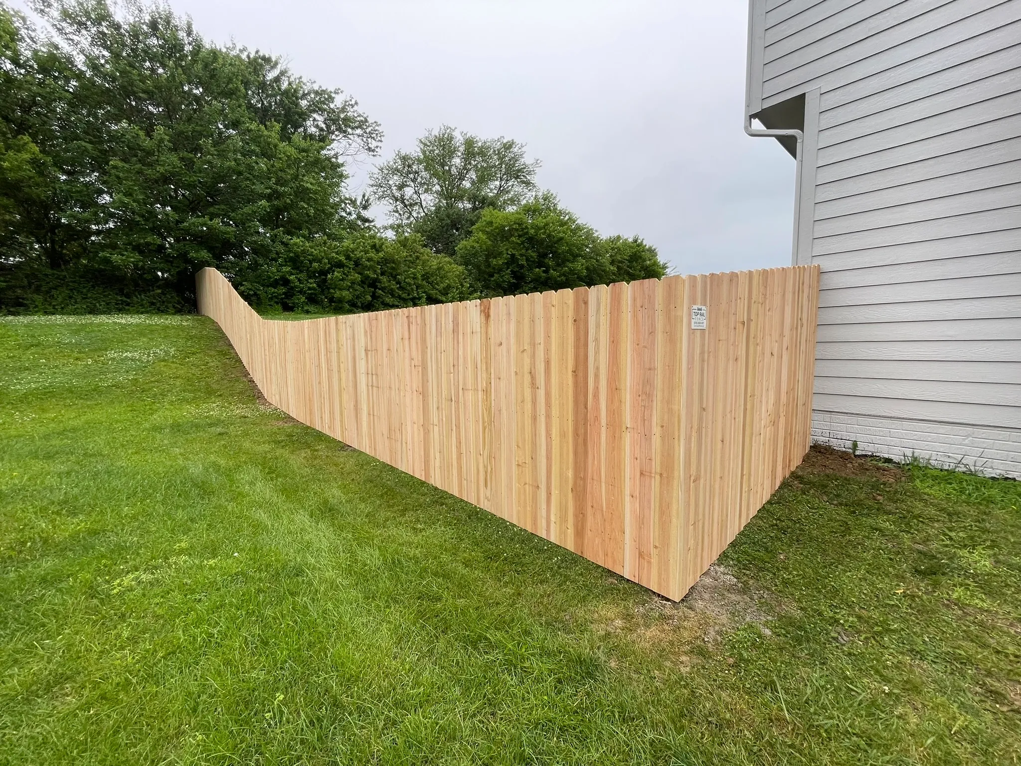 wood stockade fence installed by top rail fence