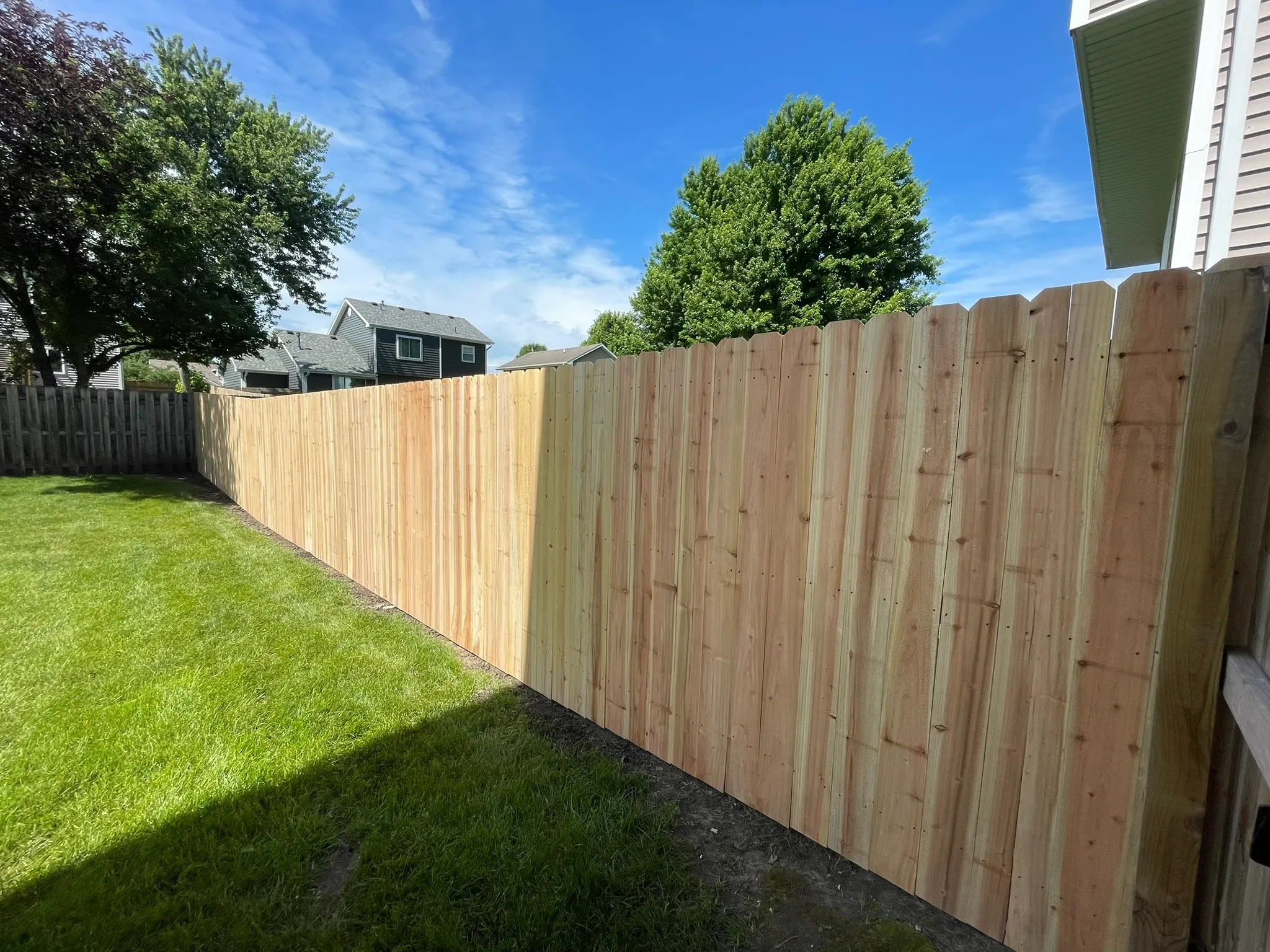 wood stockade fence installed by top rail fence