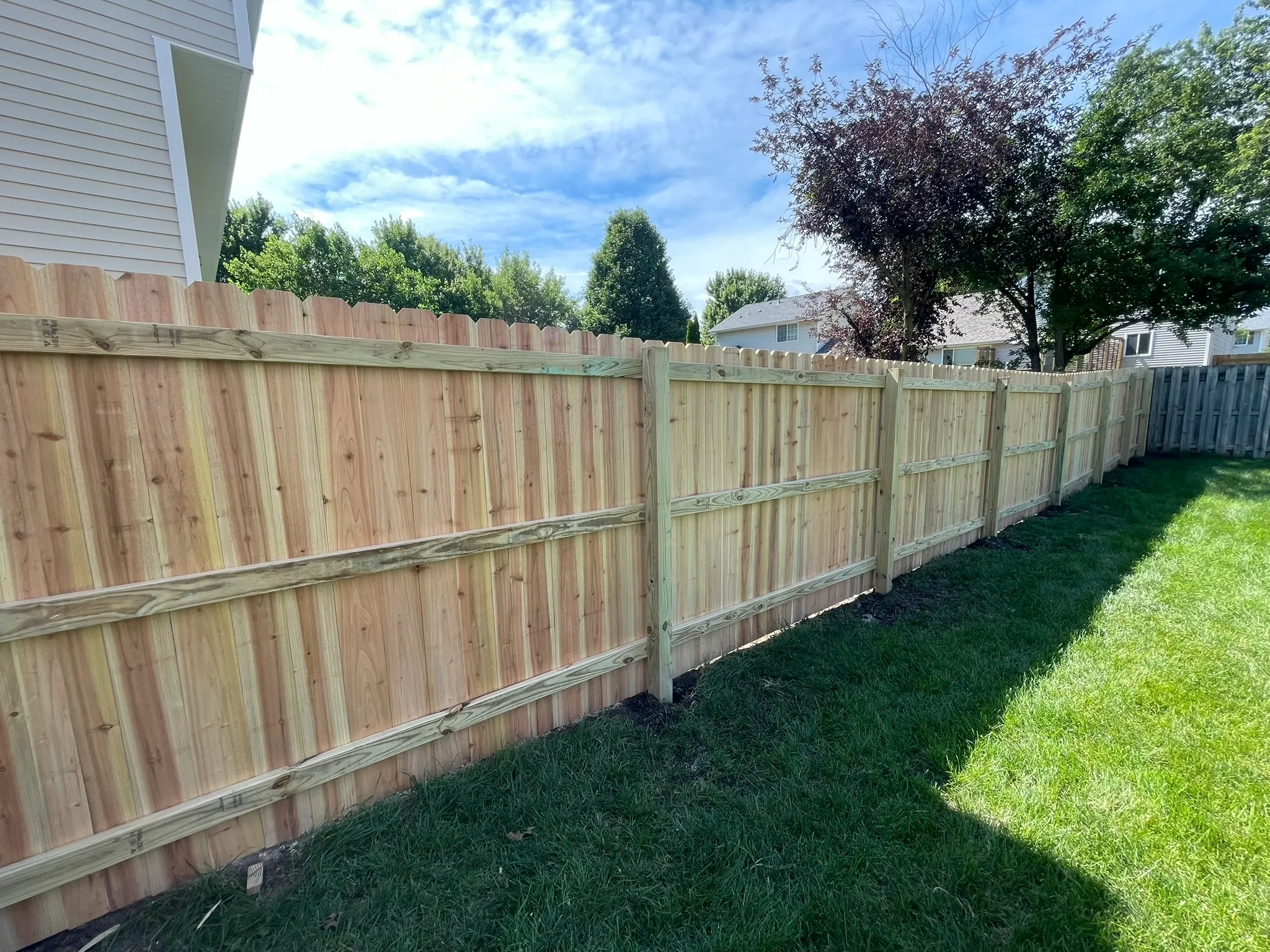 wood stockade fence installed by top rail fence