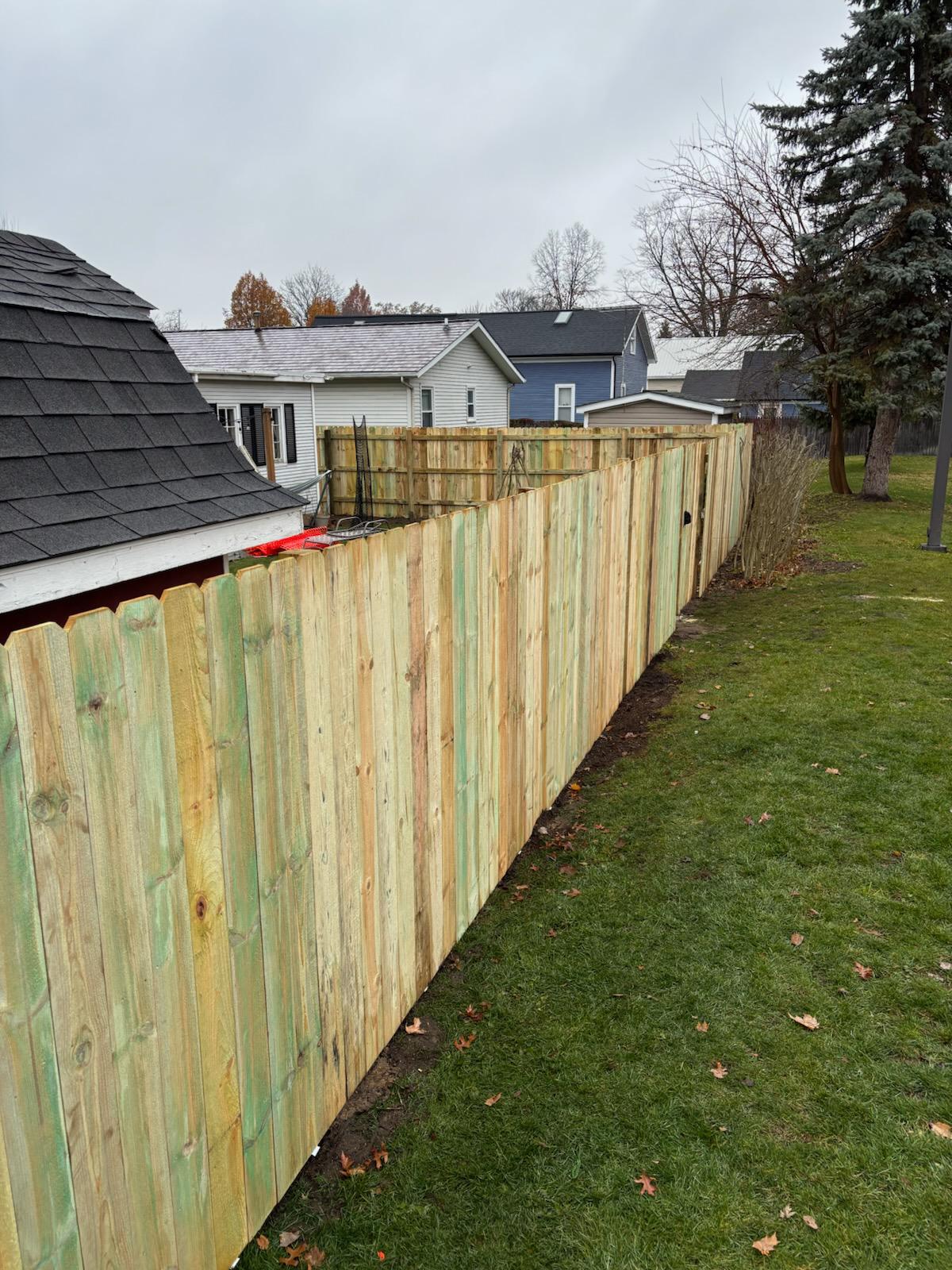 wood stockade fence installed by top rail fence