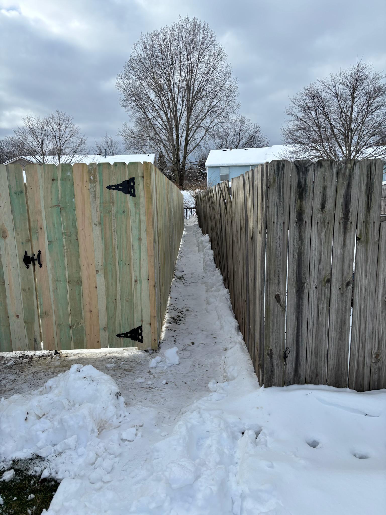wood stockade fence installed by top rail fence