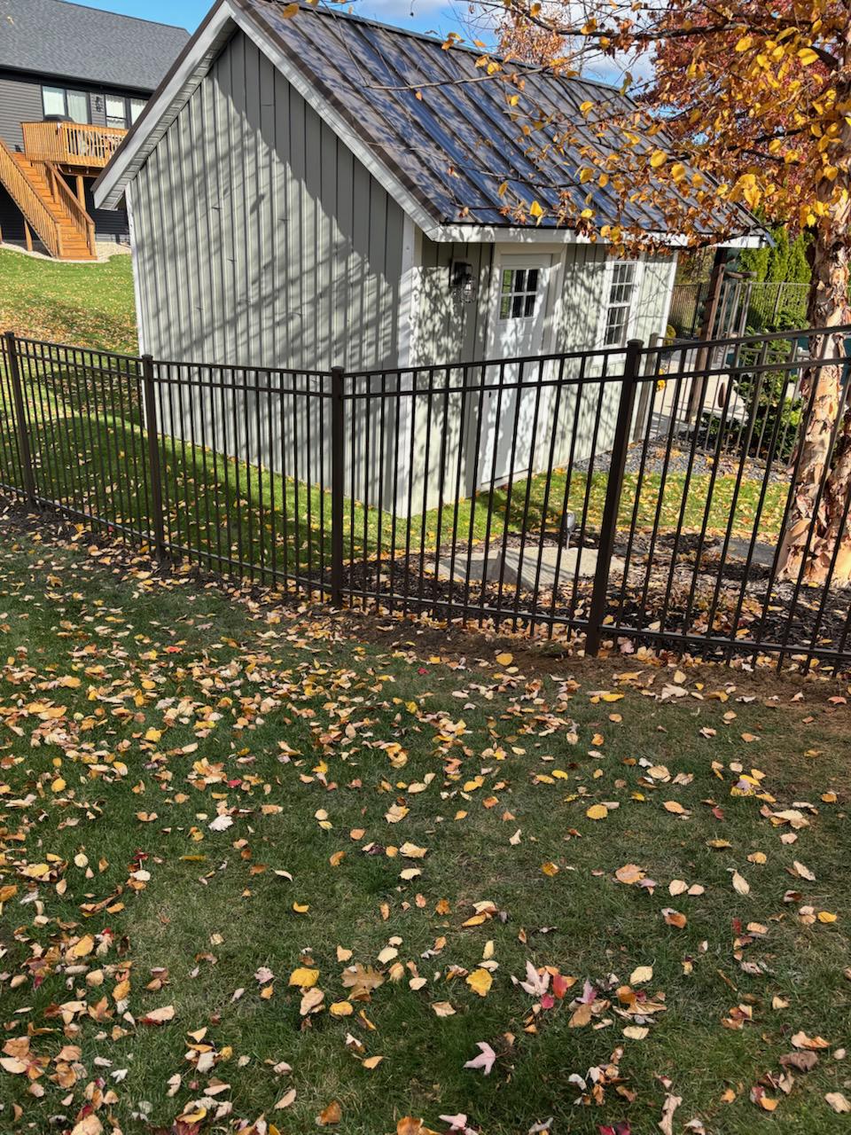 ornamental metal fence installed by top rail fence