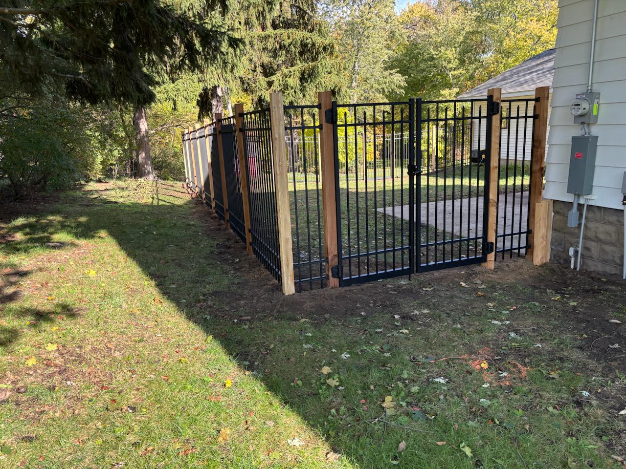 ornamental metal fence installed by top rail fence