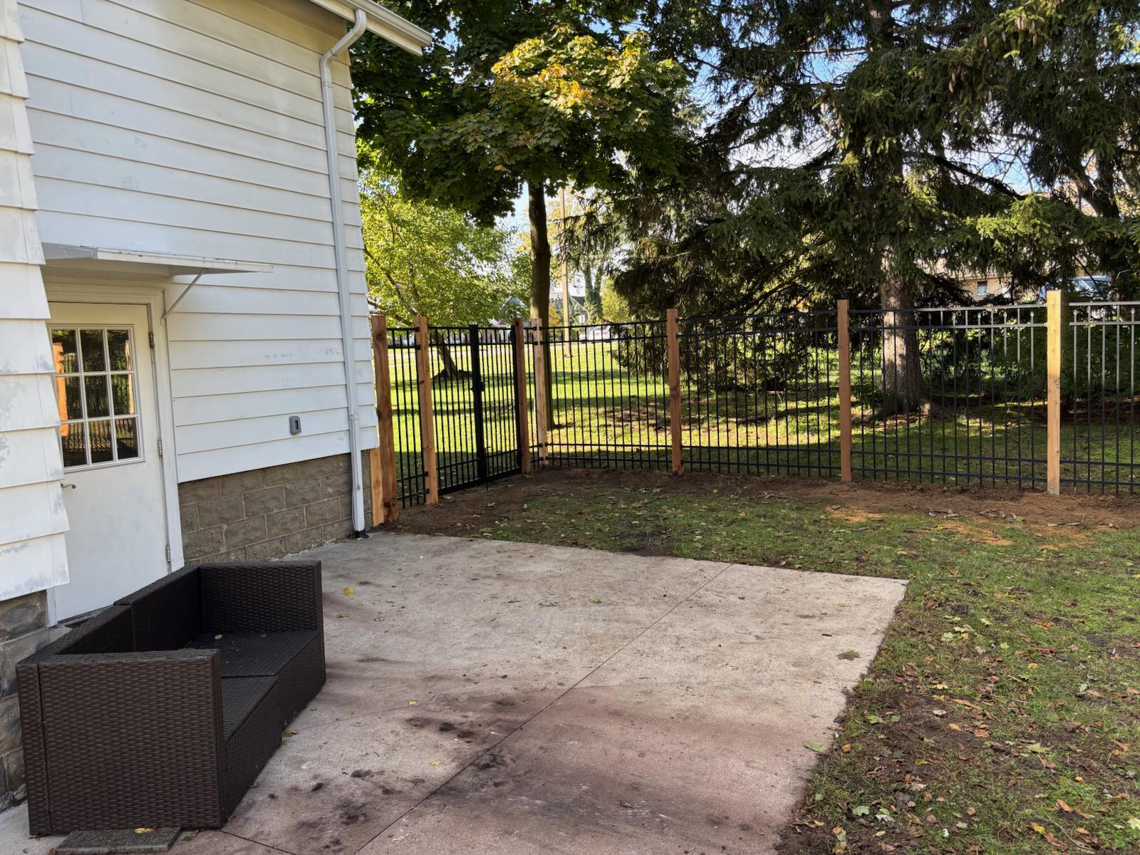 ornamental metal fence installed by top rail fence