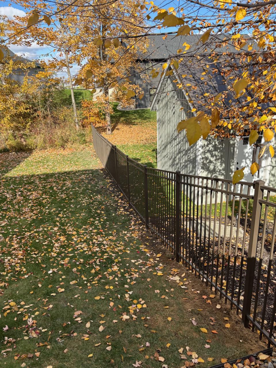 ornamental metal fence installed by top rail fence