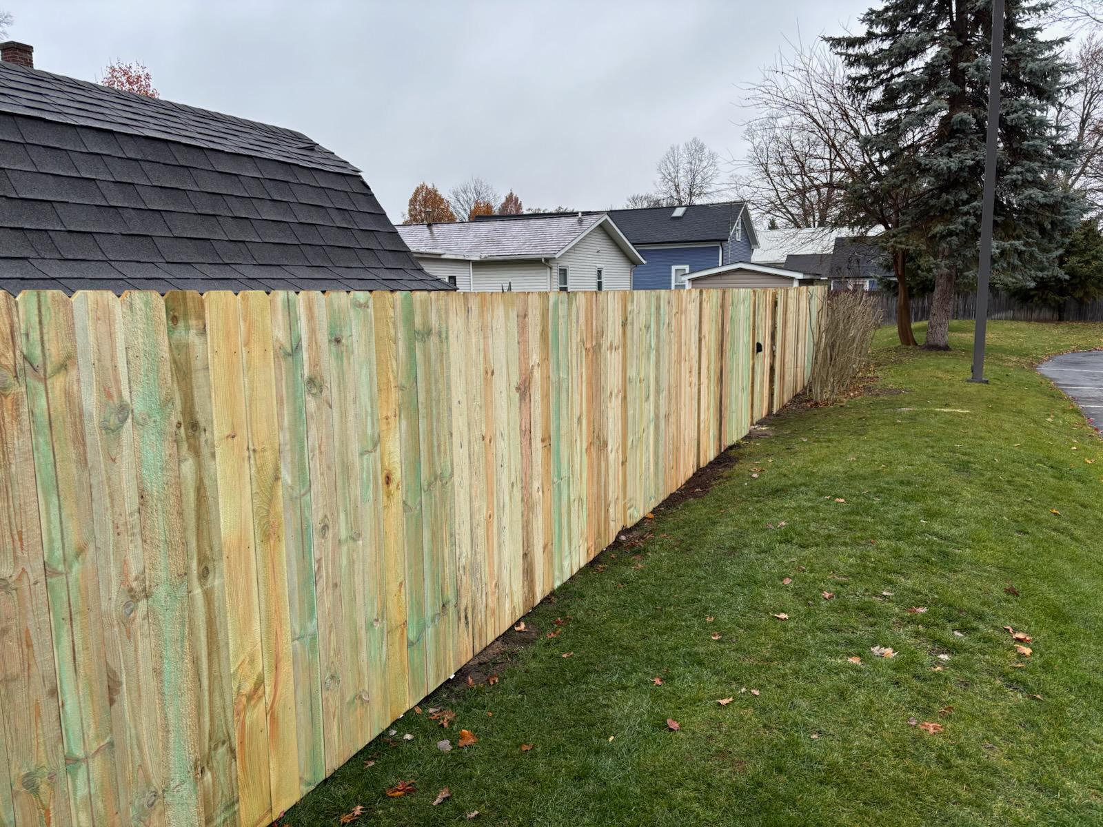 wood stockade fence installed by top rail fence