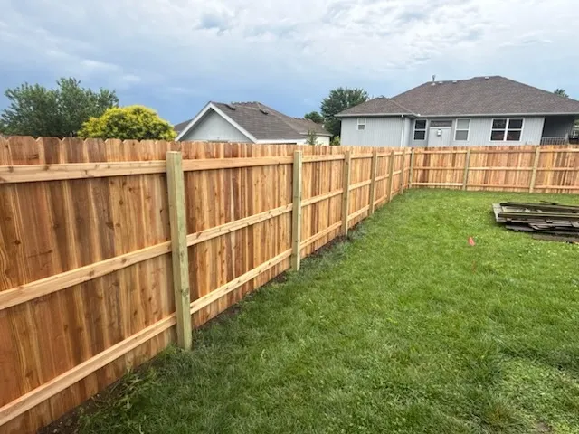 wood stockade fence installed by top rail fence