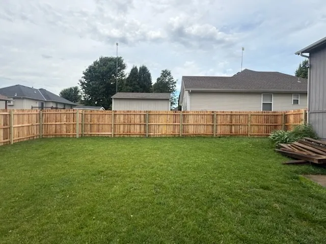 wood stockade fence installed by top rail fence