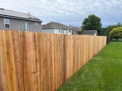 wood stockade fence installed by top rail fence