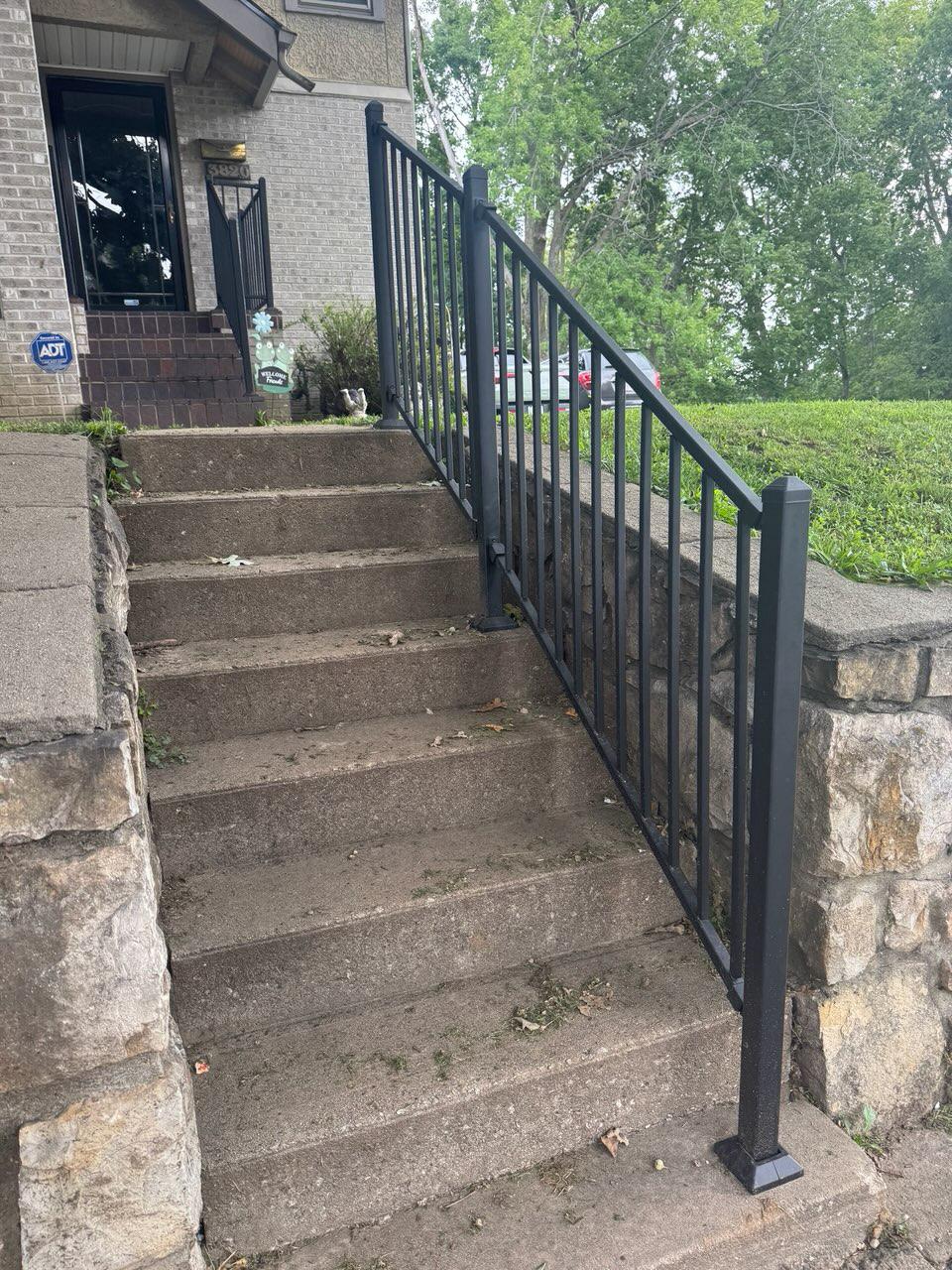 ornamental metal railing installed by top rail fence