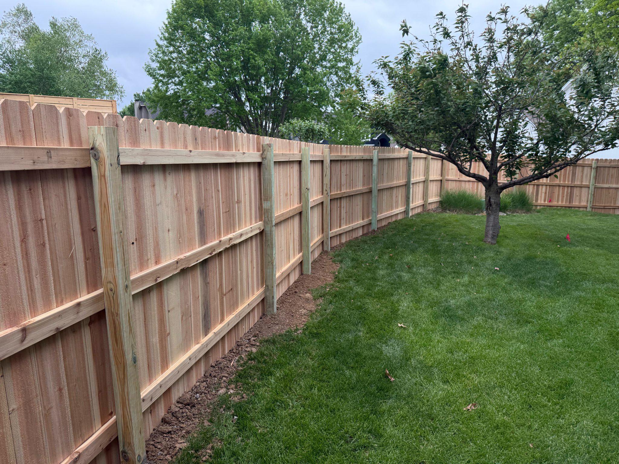 wood stockade fence installed by top rail fence