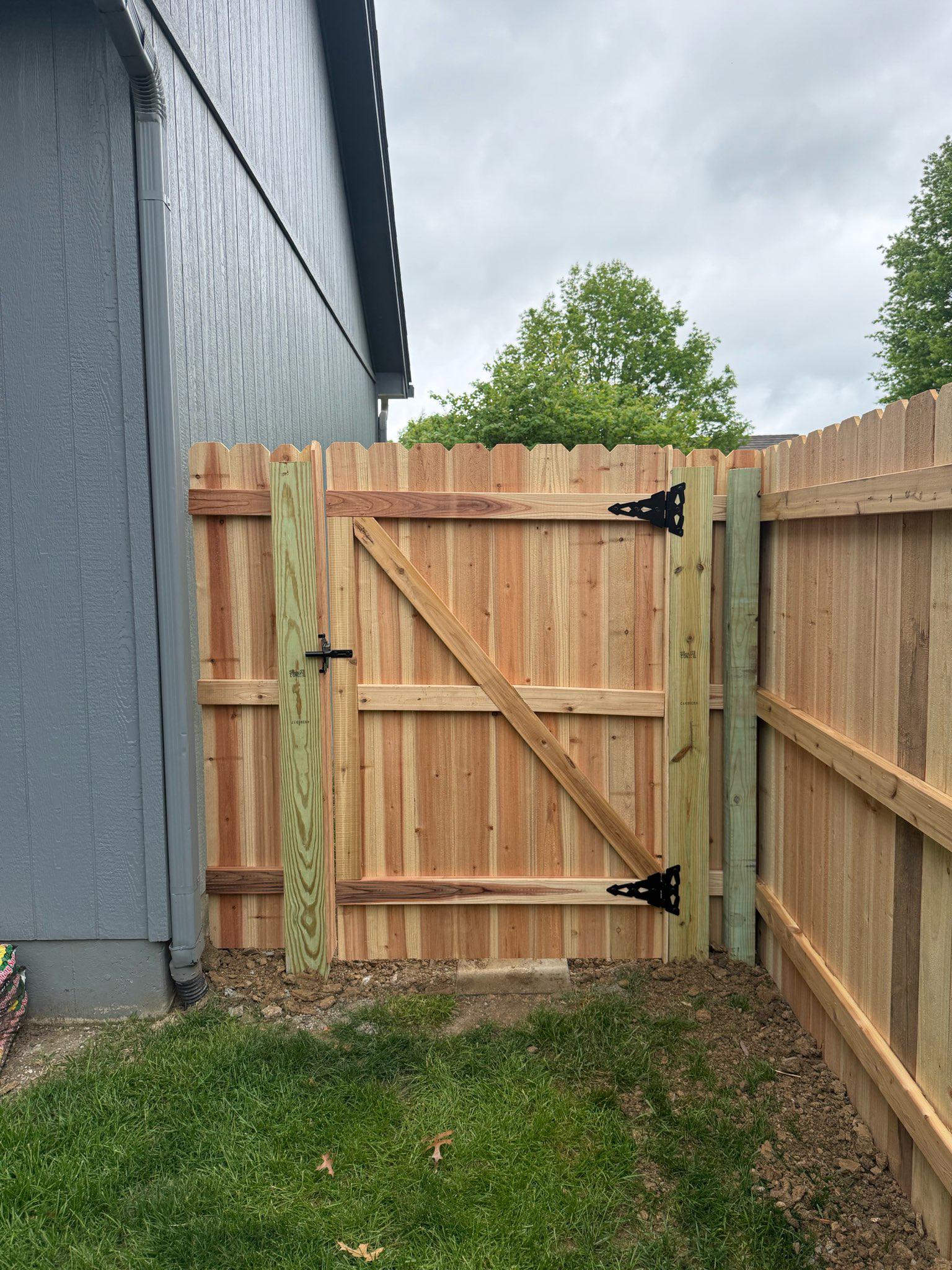 wood stockade fence installed by top rail fence