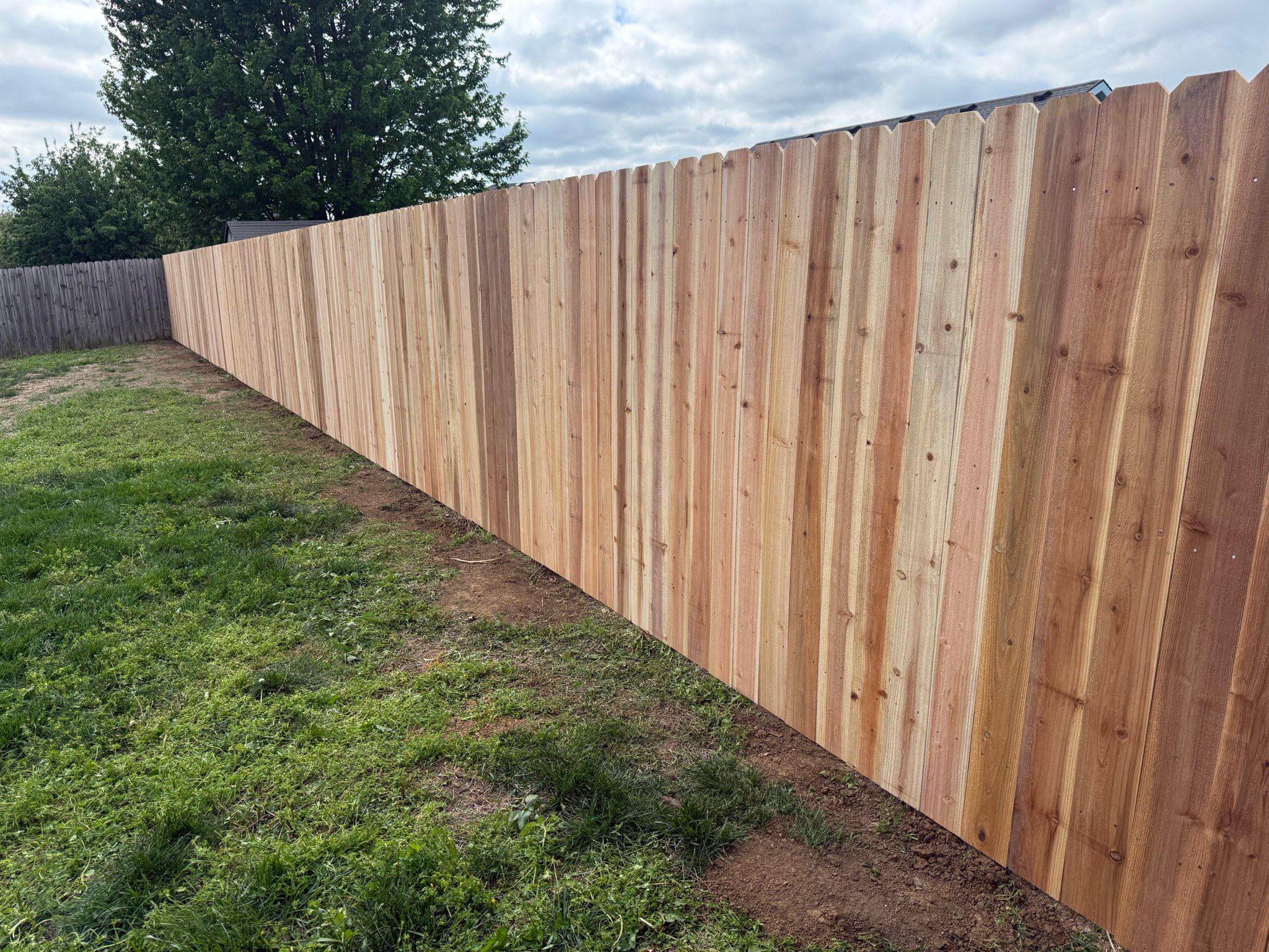 wood stockade fence installed by top rail fence