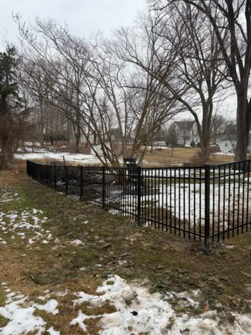 ornamental metal fence installed by top rail fence