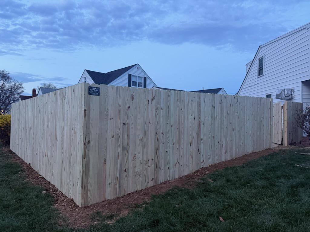wood stockade fence installed by top rail fence