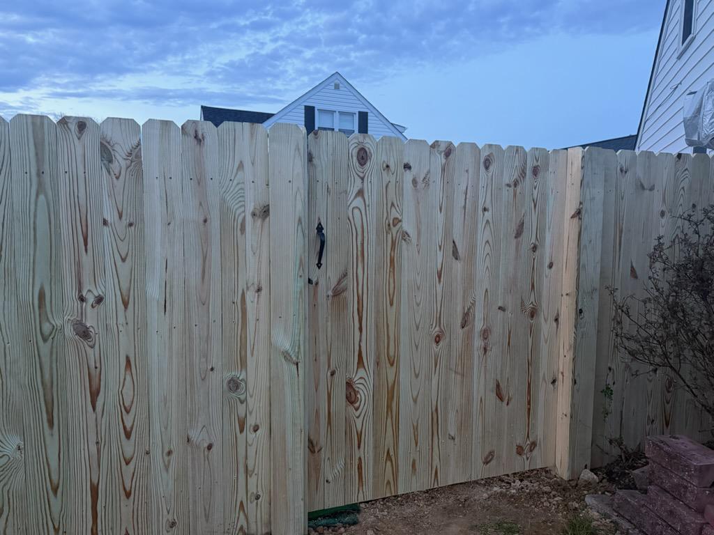 wood stockade fence installed by top rail fence