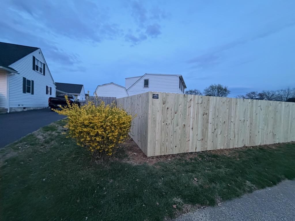 wood stockade fence installed by top rail fence