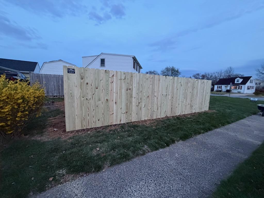 wood stockade fence installed by top rail fence