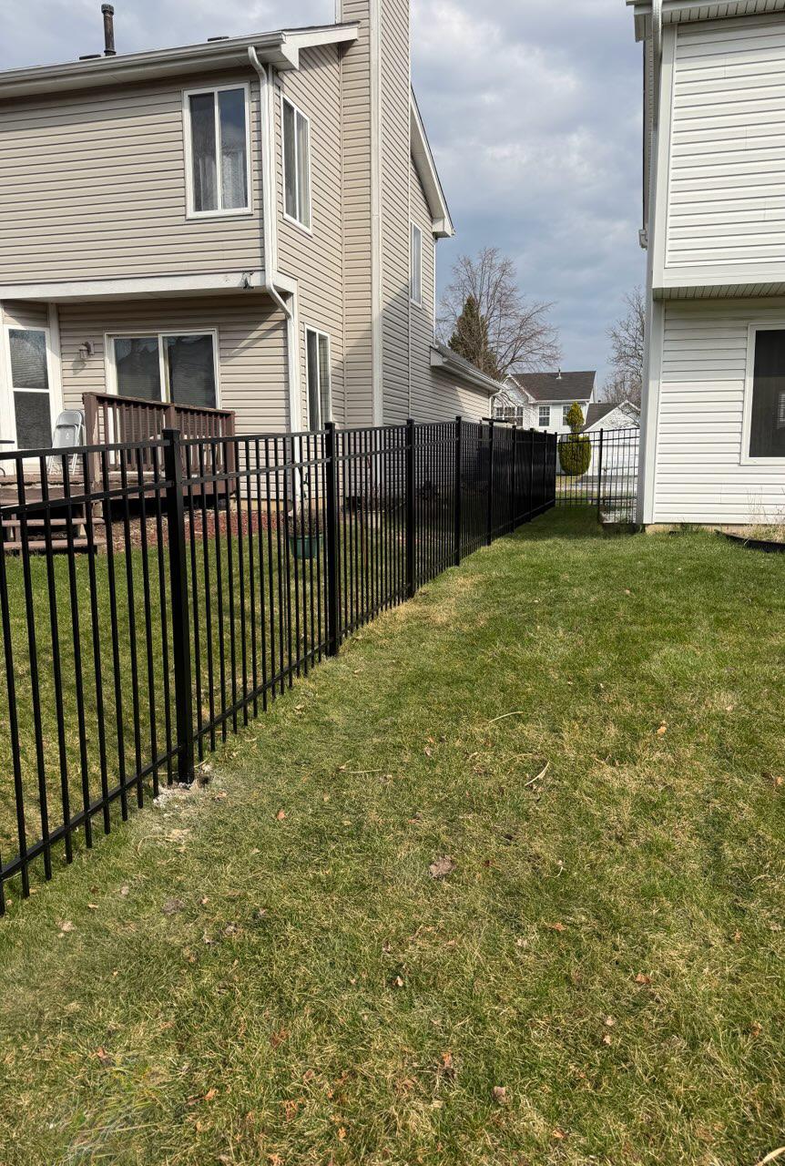 ornamental metal fence installed by top rail fence