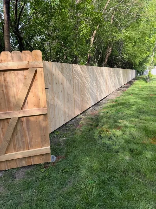 wood stockade fence installed by top rail fence